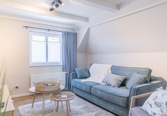 Wohnzimmer mit Sofa und TV-Smöögsch Lagune Büsum- Ferienhaus / Ferienwohnung Büsum - 4