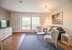 Wohnzimmer mit Sofa und TV-Ferienwohnung Keyser 2.0- Ferienhaus / Ferienwohnung Büsum - 4