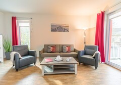 Wohnzimmer mit Sofa-Nordlichter - Ferienhaus / Ferienwohnung Büsum - 3